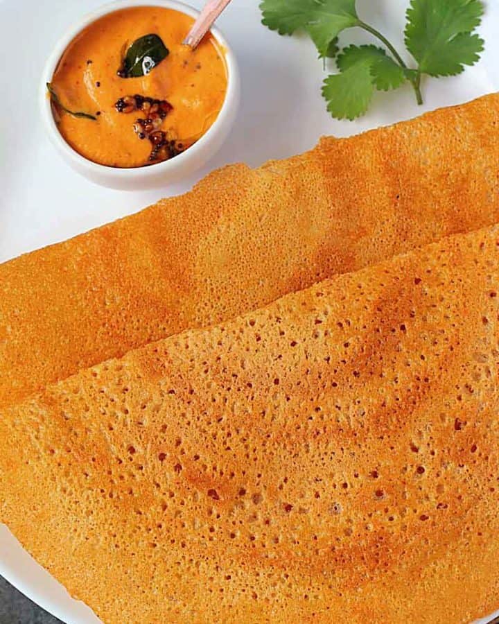 adai dosa in a white plate with chutney