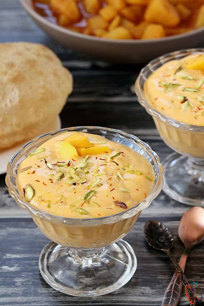 Mango Shrikhand | Aamrkhand - Lush Mango flavored Popular Indian Dessert made with Greek or Thick yogurt, Mango, sweetener, Cardamom, some pistachios and aromatic Saffron.