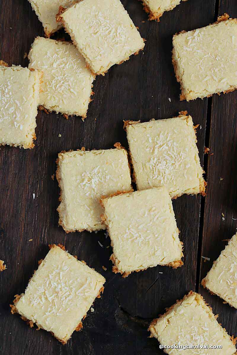 eggless coconut cookies on a brown wooden board
