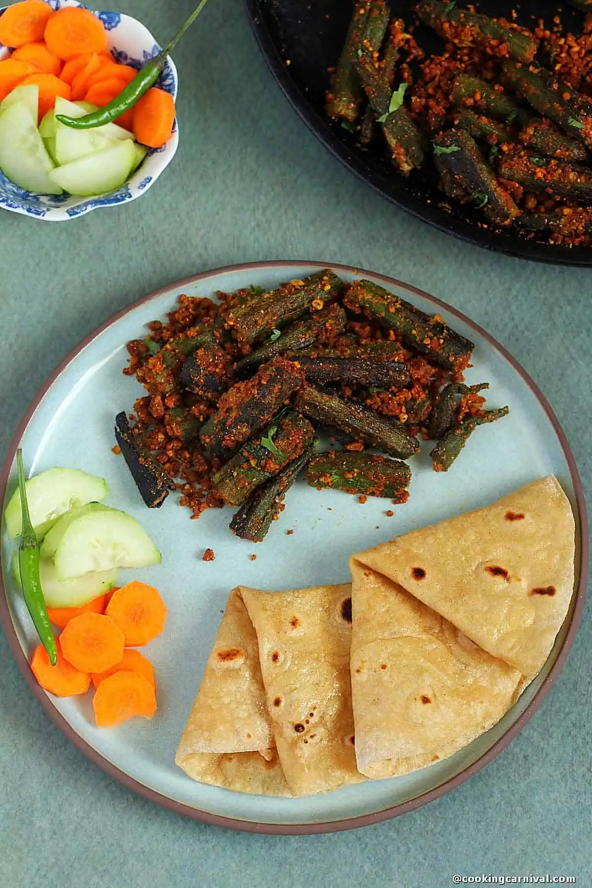 Tawa bhindi fry, roti, salad on a plate.