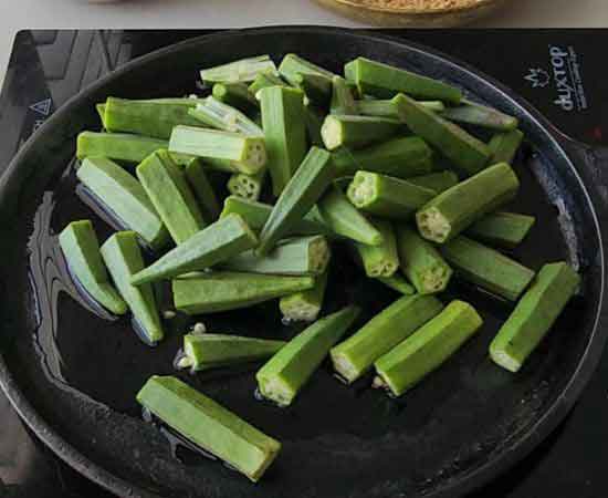 Cooking bhindi on cast iron tawa.