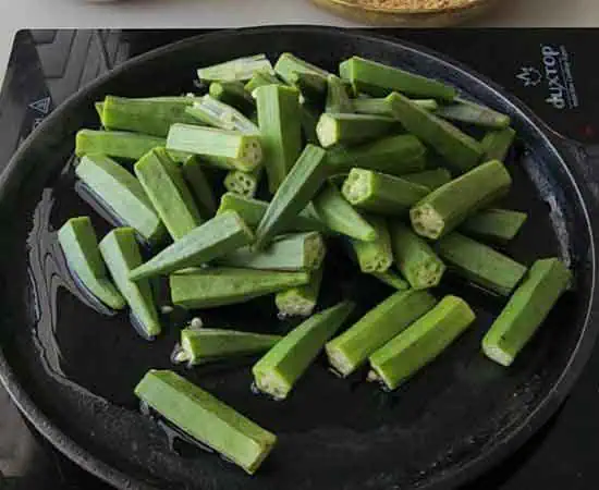 Cooking bhindi on cast iron tawa.