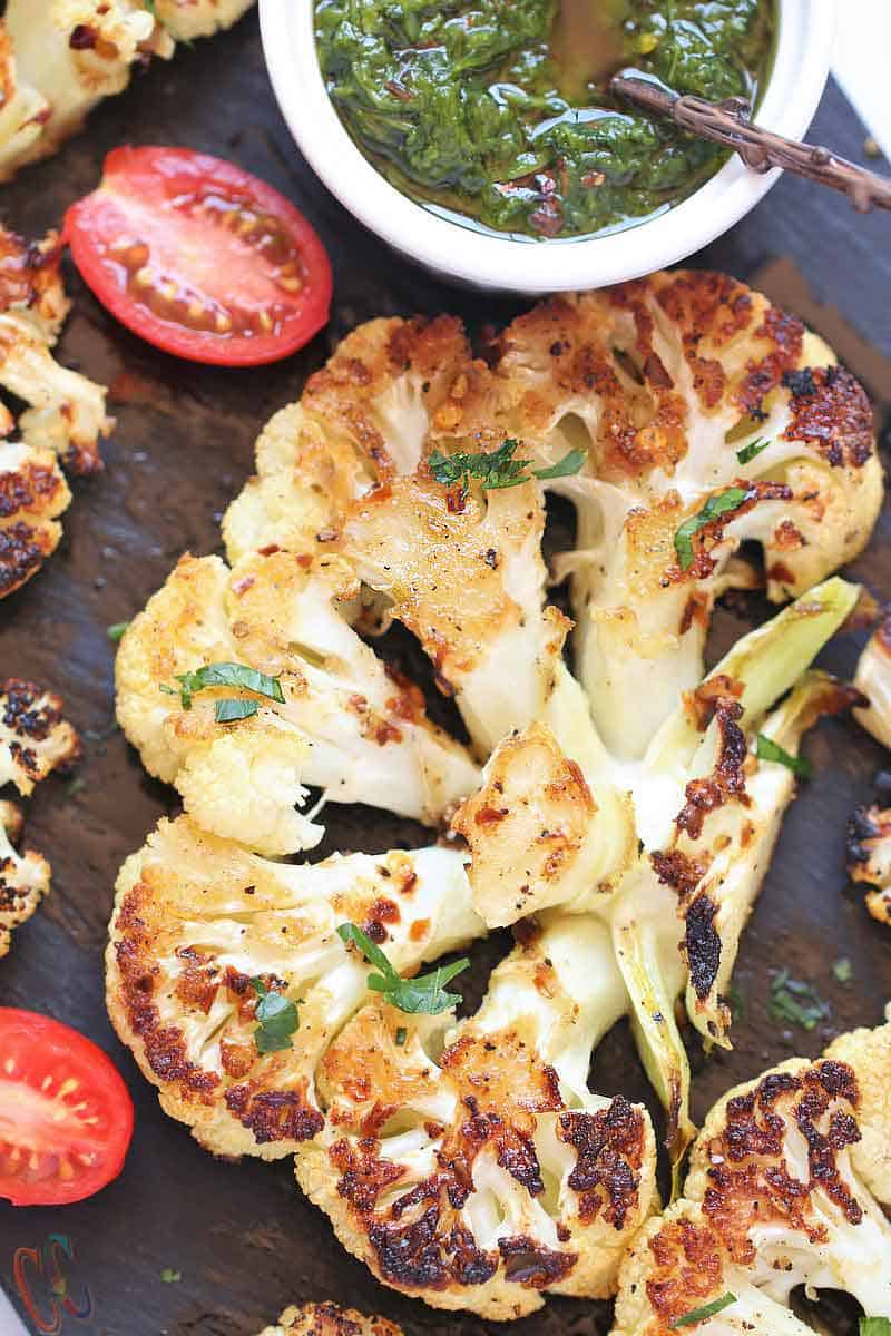 Roasted Cauliflower Steak - A completely Healthy, flavorful and delicious way to cook cauliflower in oven and enjoy it during summer BBQ party or pool party! Serve it with Flavorful Sauce like Chimichurri or Avocado sauce and you'll have most satisfying, hearty entree or side dish ready!