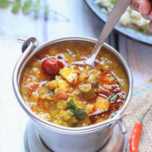 Mango Dal - Andhra Style Vegan Mango Dal recipe in the instant pot/pressure cooker. Toor Dal (Split Pigeon pea) cooked with Grated Raw mango and tempered with red dried chilies, ginger, garlic, green chilies, onion, curry leaves, cumin seeds and with basic spices.