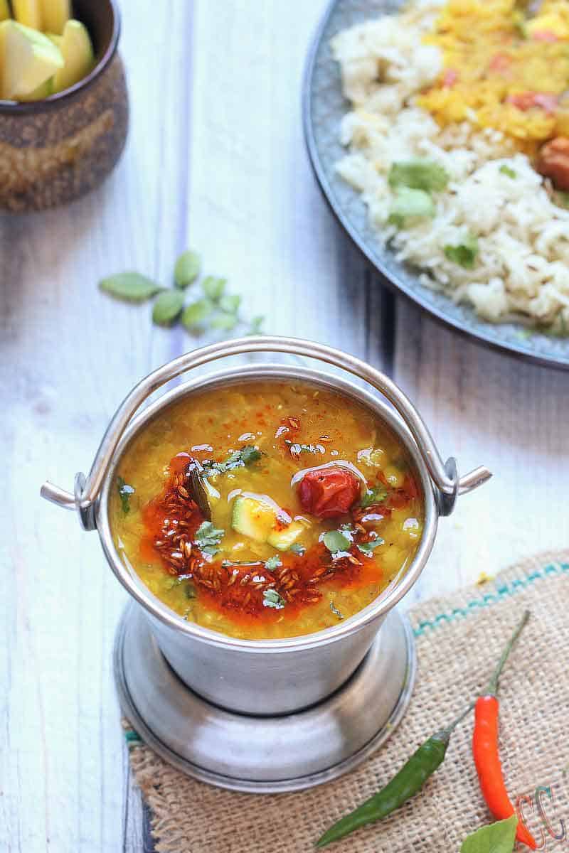 Mango Dal - Andhra Style Vegan Mango Dal recipe in the instant pot/pressure cooker. Toor Dal (Split Pigeon pea) cooked with Grated Raw mango and tempered with red dried chilies, ginger, garlic, green chilies, onion, curry leaves, cumin seeds and with basic spices.