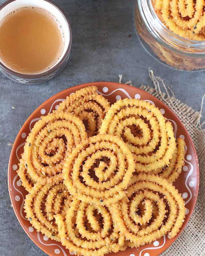 Chakli in a traditional plate with cup of masala tea