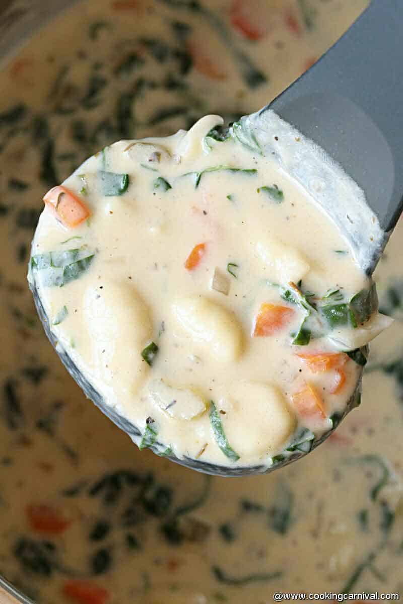 taking ladle full of gnocchi soup from instant pot