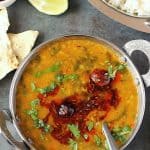 Spinach dal in a bowl with spoon