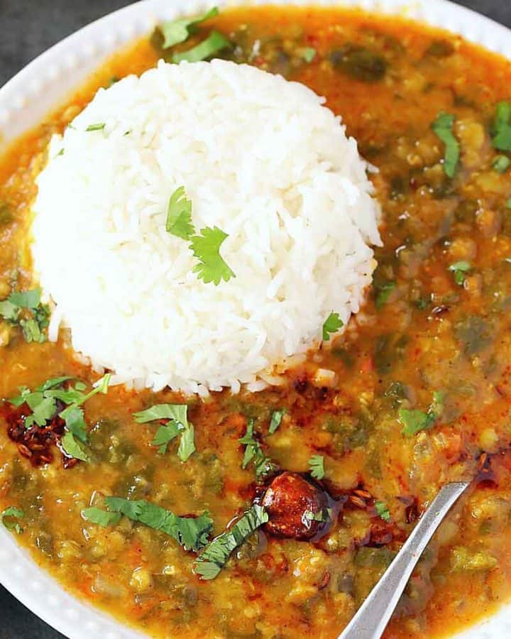 Dal palak on white plate with steamed rice