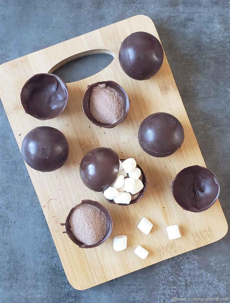 filling the chocolate balls with marshmallow and cocoa mix