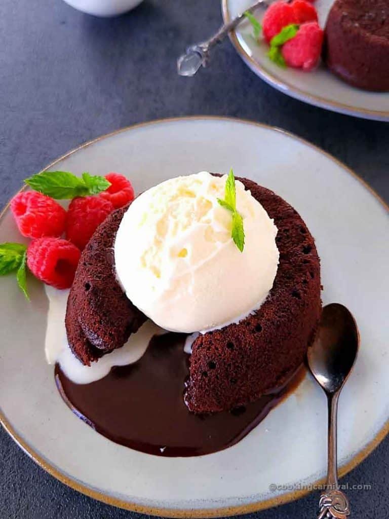 Eggless chcolate lava cake served with vanilla ice cream, berries and mint