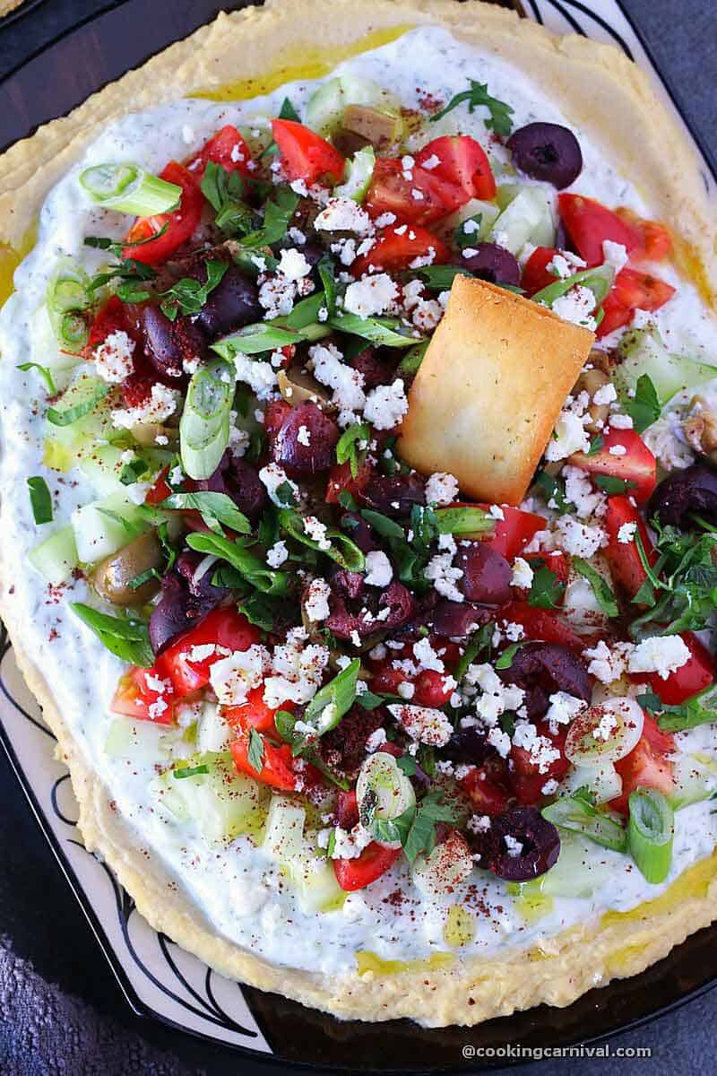 7 layer greek dip served with pita chips