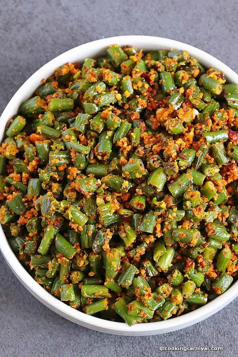 green beans ki sabji (Indian green beans stir-fry) in a white bowl