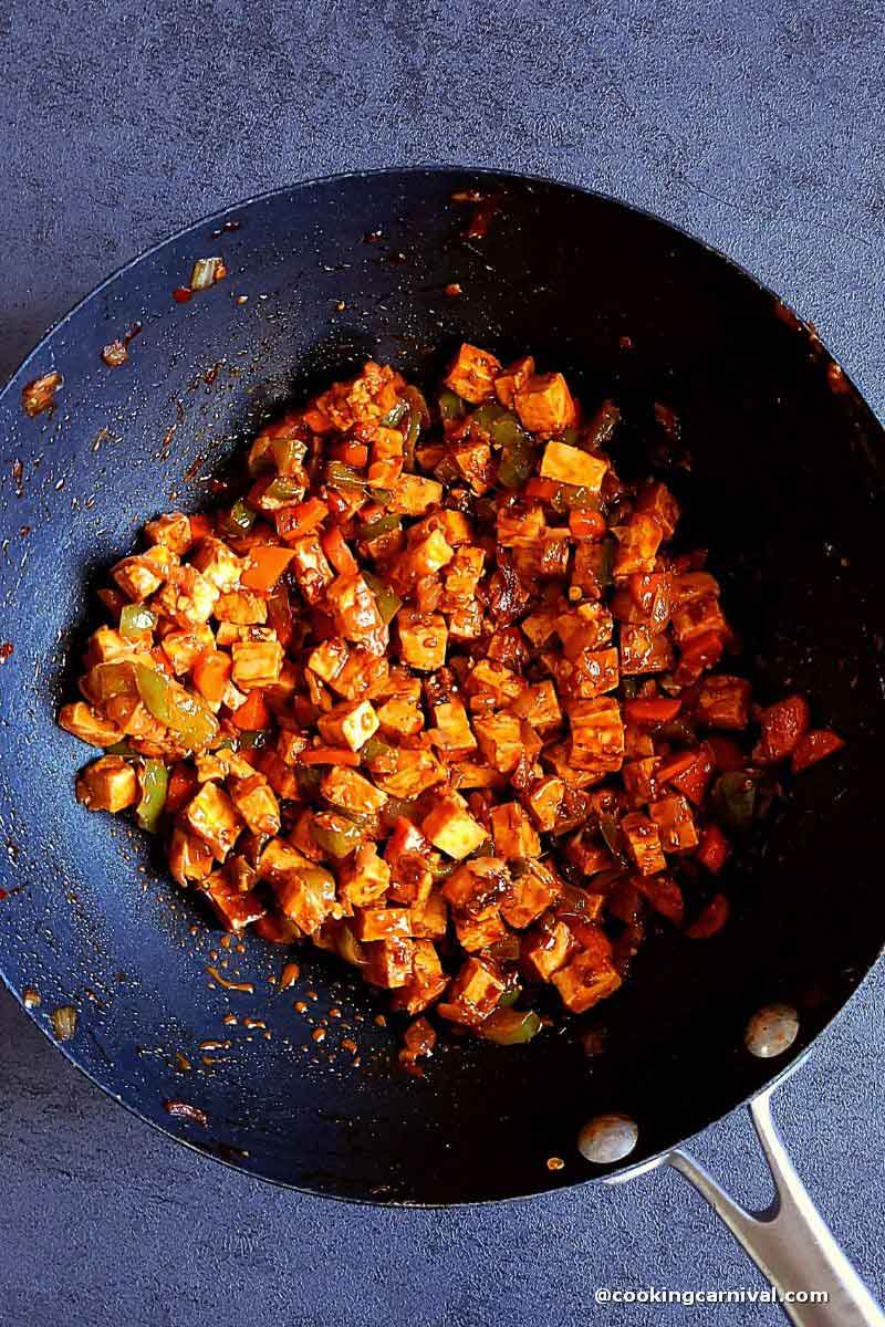 schezwan paneer stuffing made for making puff pastry, in a wok.