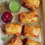 Schezwan Paneer Puff served with green chutney and tomato ketchup.