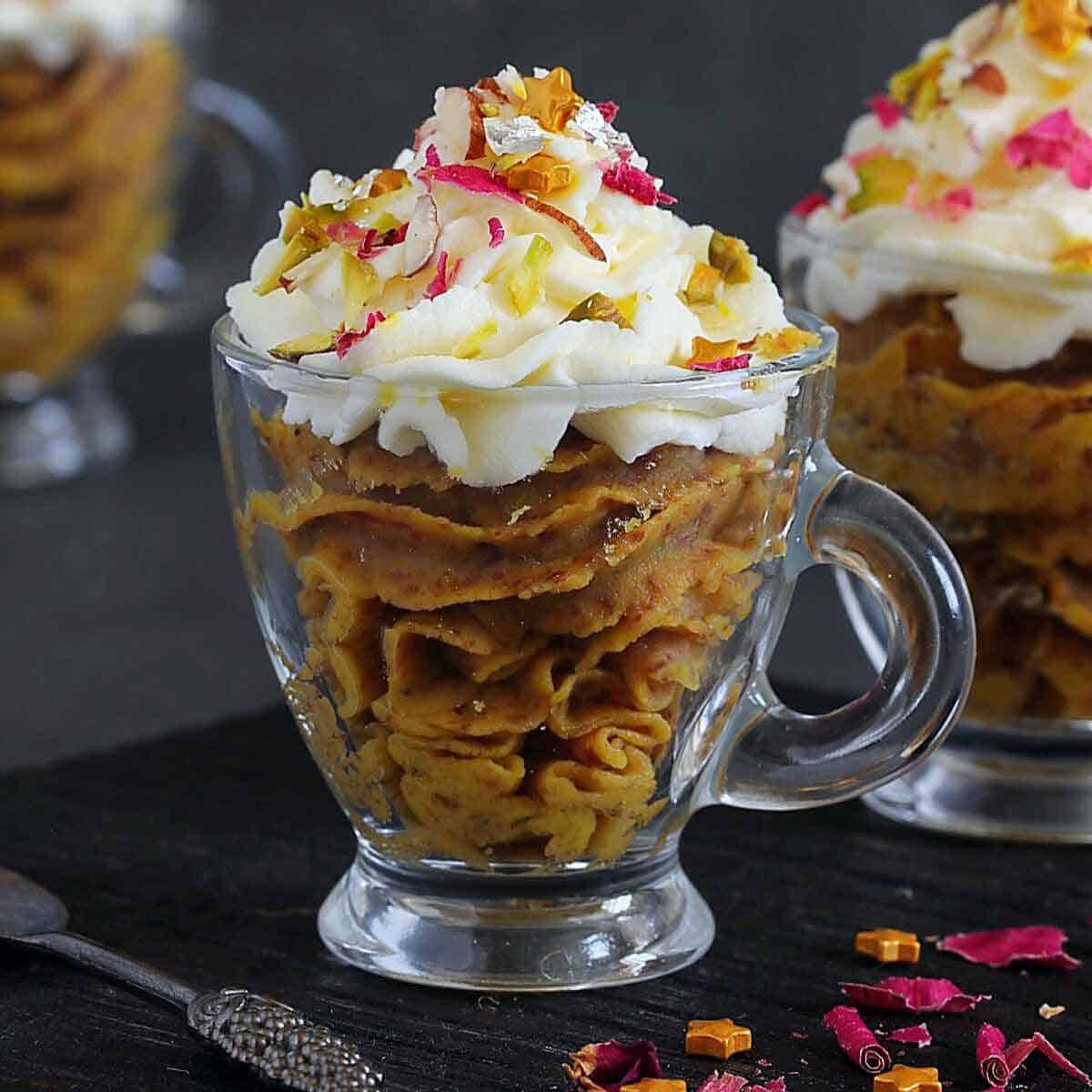Mohanthal cups with whipped cream.