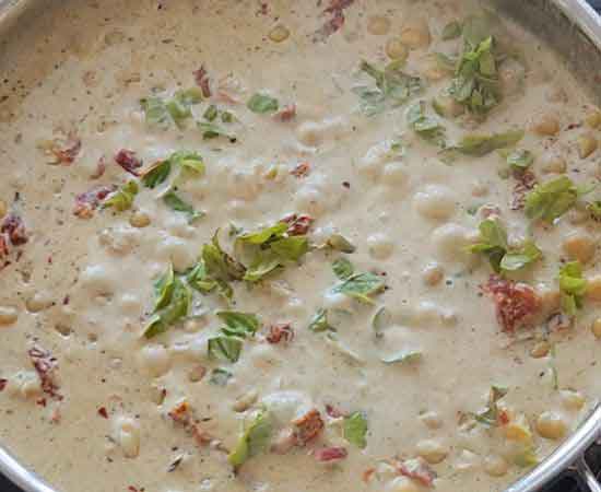 adding fresh basil in marry me chickpeas recipe.