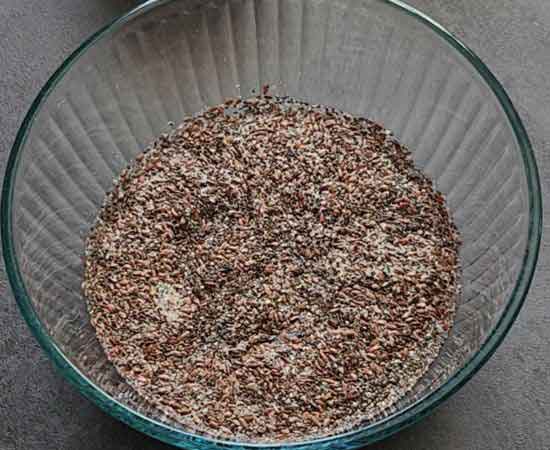 flex seeds, chia seeds and warm water in a bowl.