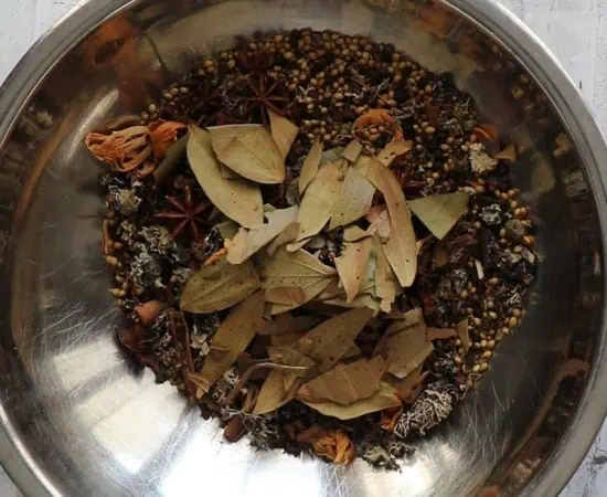 Toasted whole spices in a mixing bowl