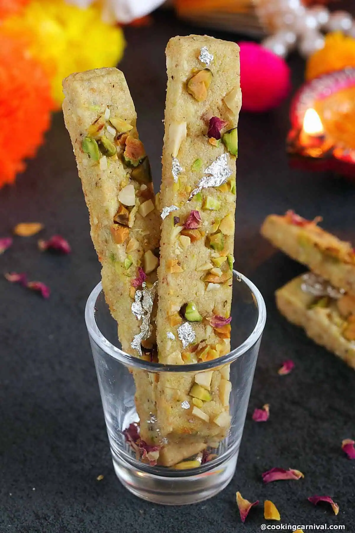Mawa gujiya cookie sticks in a glass.
