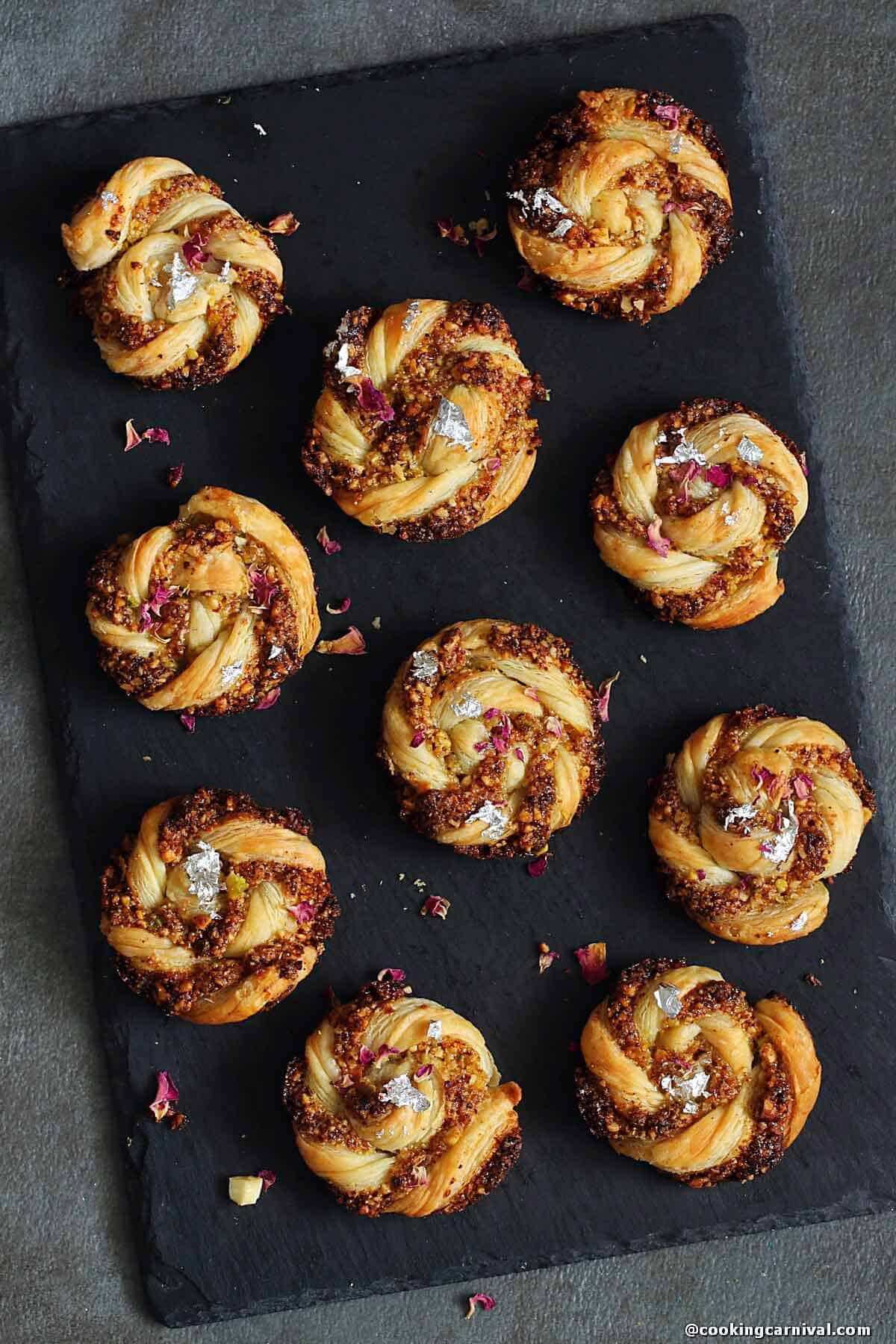 puff pastry gujiya swirls on a cheese board.