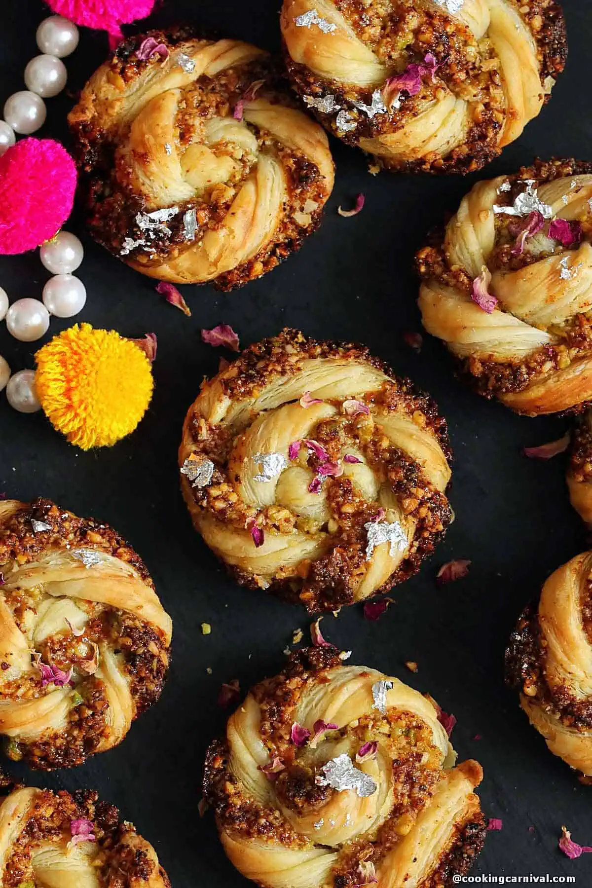 Puff Pastry gujiya swirls on a black board.