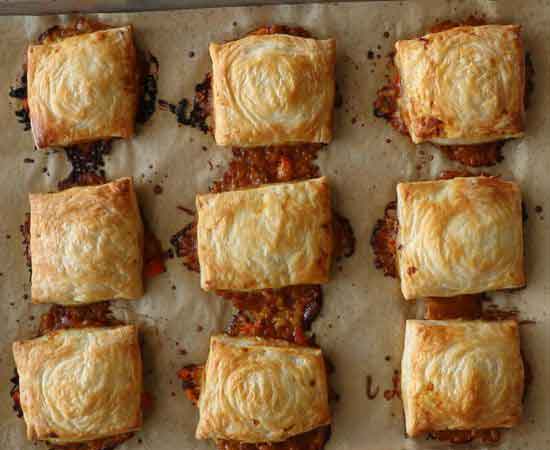 Puff pastry with masala baked beans on a baking tray.