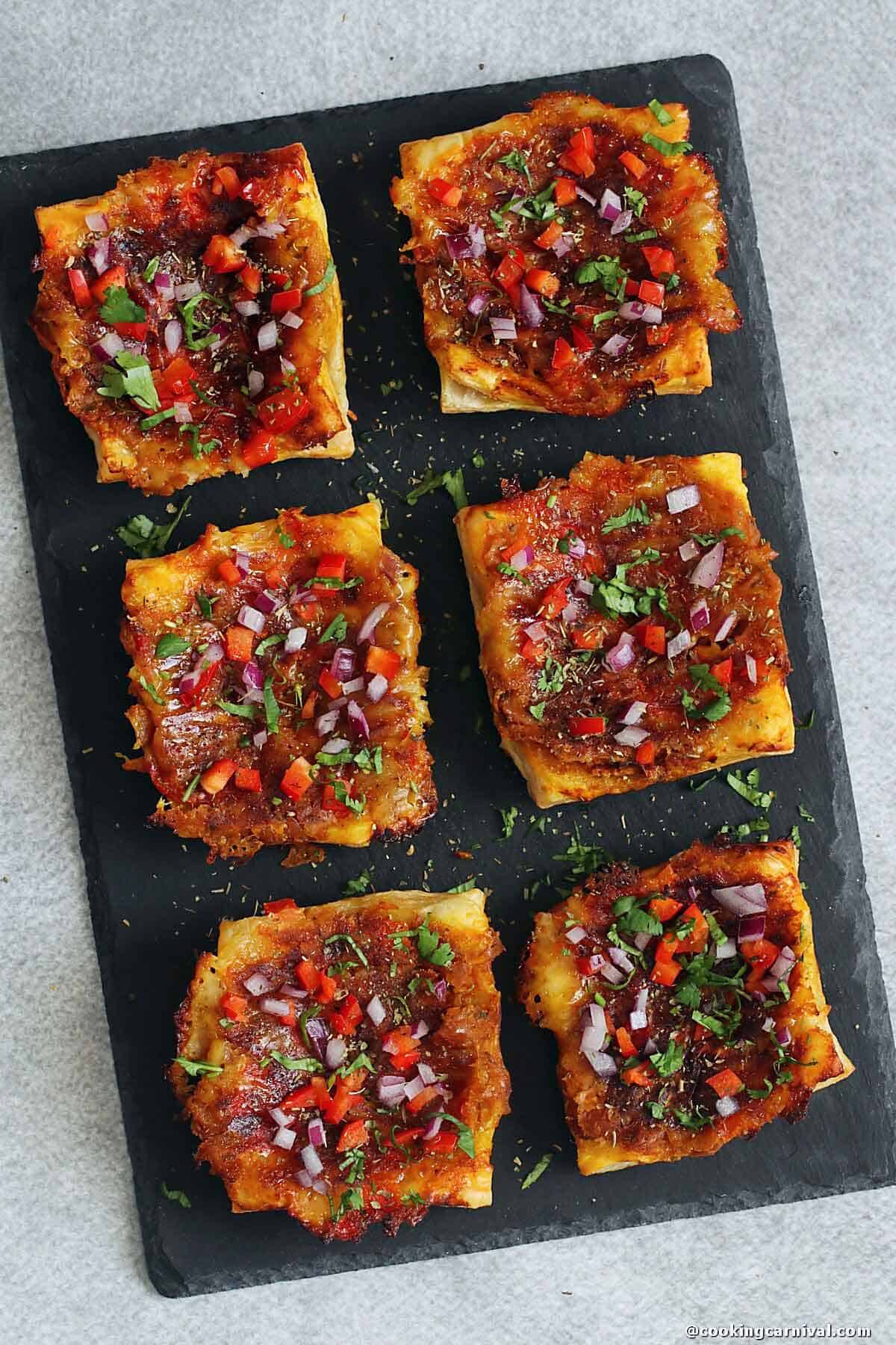 Masala Baked beans puff pastry on black board.