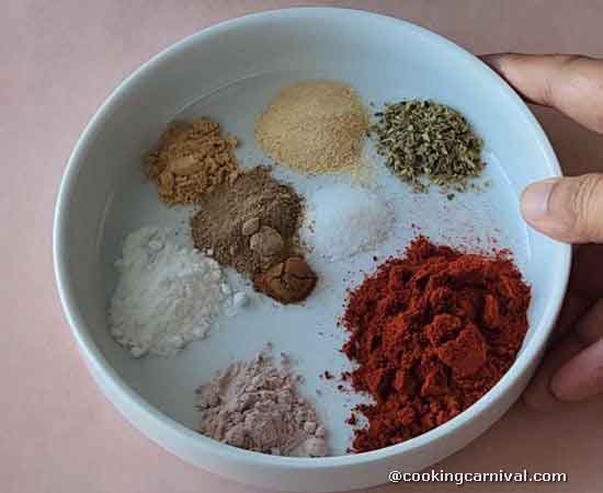 peri peri masala spices in a white bowl.