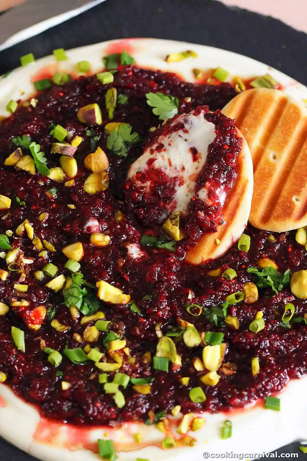 Masala cranberry salsa over whipped ricotta and goat cheese, served with mini naans.