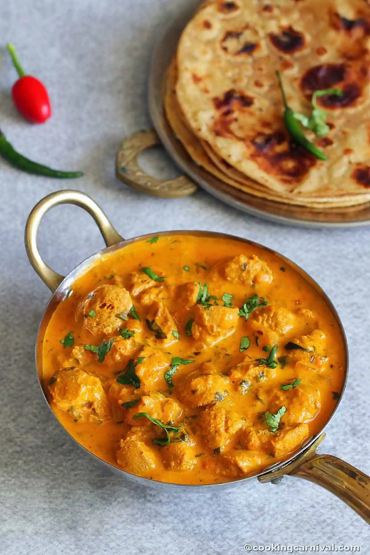 Methi Soya Chunks Curry in a steal bowl. plain parathas on the side.