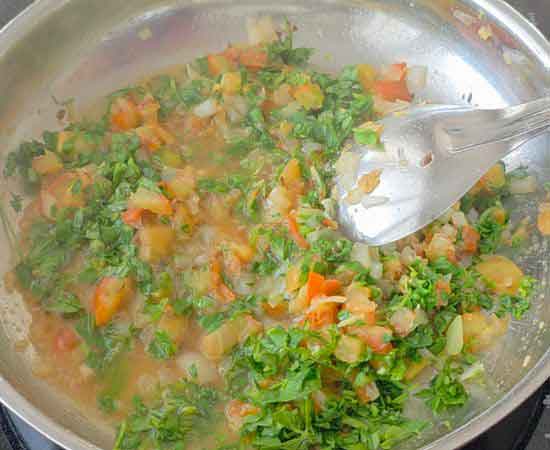 cooking garlic, ginger, onion, tomato, methi in oil.