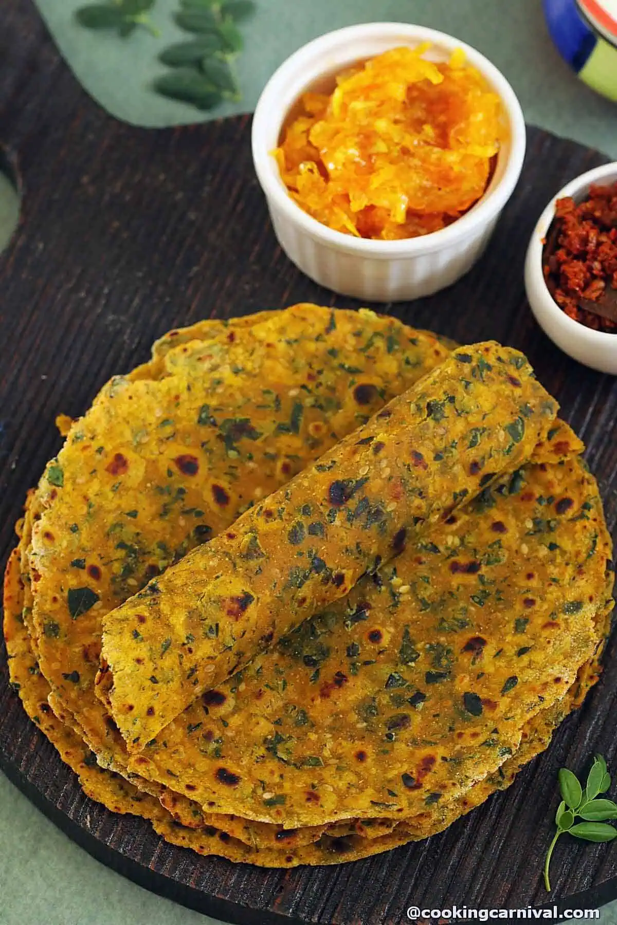 Multigrain Moringa Thepla recipe with chundi on the board.