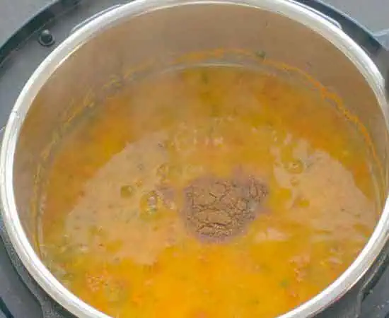 adding garam masala and lemon juice in cooked dal.