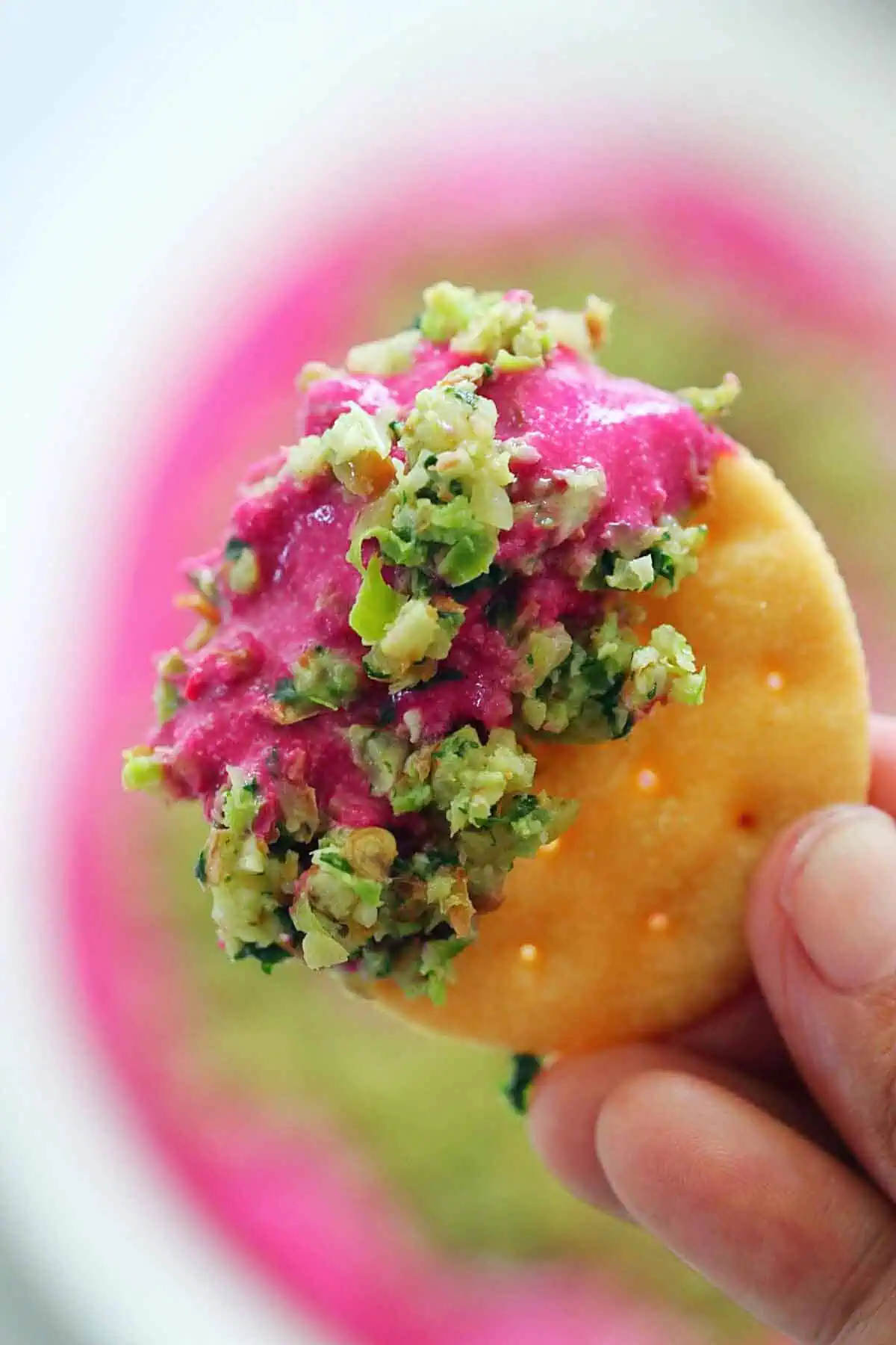 holding papdi with beet paneer dip and thecha.